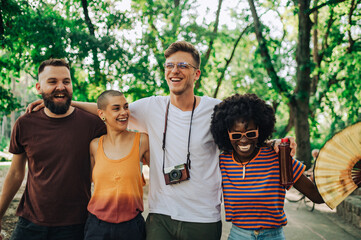 Portrait of multicultural travelers taking a walk in park together.