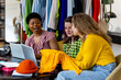 Concept of diversity, teamwork, women doing project together. Group of young females, university students working on fashion startup, online clothes resale. Small business, African American, caucasian