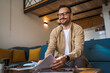 © Miljan Živković - Adult man with eyeglasses read and watch document work at home