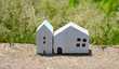Miniature wooden house on green grass