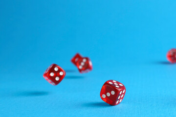 Sticker - Many red game dices falling on light blue background