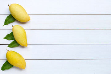 Sticker - Tropical fruit, Mango on white wooden background.