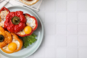 Wall Mural - Delicious stuffed bell peppers with fried eggs on white tiled table, top view. Space for text