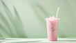 refreshing strawberry milkshake in a takeaway cup on a green pastel background, with copy space for text