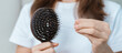 Hair loss problem, Balding , Beauty treatments and health care concepts asian woman holding holding comb with hair loss, young female hold hairbrush and brushing with fall hair from scalp