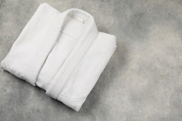 White kimono on gray background, top view. Space for text