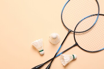 Sticker - Feather badminton shuttlecocks and rackets on beige background, flat lay. Space for text