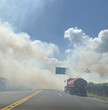 White smoke from fire over highway