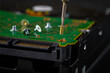 © PicMedia - Hard disk drive and printed circuit board with SATA power connector. Magnetic driver torx bit and small machine screw