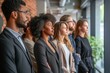 © Iigo - Multiethnic group of businesspeople standing in a row in office
