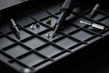 Torx Drive Bit And Aluminum Bit Driver On Black Sorting Tray. Screws And Drive Bits. Screwdriver Handle With Magnetic Bit Socket And Knurled Grip.