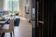 Digital Door handle or Electronics knob  for access to room security, Black Door wooden half opening through blur interior living room background, selective focus,
