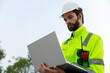 © eakgrungenerd - Engineer wearing safety uniform holding laptop discussed plan about renewable energy at station energy power wind. technology protect environment reduce global warming problems.