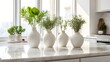 Interior design of an apartment or kitchen including solitary vases and plants on a white marble table with a white background, lens flare, and copy space