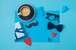Happy Fathers day creative concept with coffee cup,  heart shape and gift box on blue background. Top view, flat lay