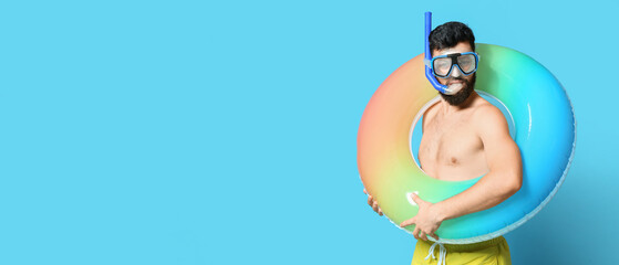 Sticker - Young man with inflatable ring and snorkeling mask on color background