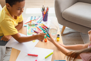 Wall Mural - Cute little children drawing at home, closeup