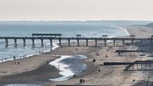 Charleston Carolina Pier At Folly Beach 2024.  Beautiful Day With Golden Light.  People Playing On The Beach.