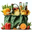 green shopping bag with groceries, soda, veggies, chips and fruits on white background
