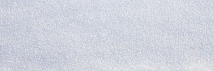 Wall Mural - Natural snow texture. Smooth surface of clean fresh snow. Snowy ground. Winter background with snow patterns. Closeup top view. Wide panoramic texture for background and design.