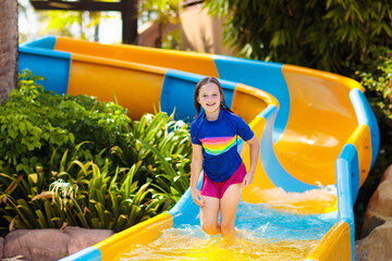 Wall Mural - Kids on water slide in aqua park. Summer vacation