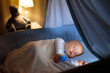 © famveldman - Baby boy in bed sleeping at night