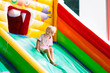 © famveldman - Child jumping on playground trampoline. Kids jump.