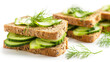 Fresh cucumber sandwiches on whole grain bread garnished with dill, showcasing a healthy and appetizing light meal against a white background.