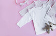 Set of baby bodysuits, pants, socks and knitted toy