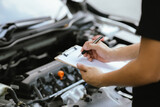 Fototapeta  - Mechanic checking engine Gather detailed information during work. Industrial plant maintenance services Until engine repair in factories, transportation, cars, vehicles