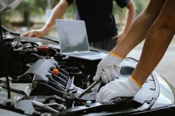 Modern mechanics use laptop computers to check engines. Gather detailed information during work. Industrial plant maintenance services Until engine repair in factories, transportation, cars, vehicles