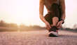 © waragron - Running shoes, closeup of woman tying shoe laces. Female sport fitness runner getting ready for jogging outdoors