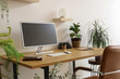 © Pixel-Shot - Modern workplace with computer monitor and houseplants near light wall in office