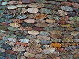 Fototapeta  - Cut pebble stone texture wall floor colorful background. Wall made from cut pebble gravel stones different shape as floor texture background. Multicolor sliced pebble cut stones wall. Cut stone wall