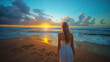 blonde woman in a white dress looking at the sea on a beach during sunset or sunrise