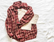 Women's red cotton plaid shirt and beige t-shirt on a light background, top view