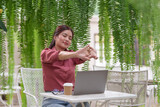 Fototapeta  - Independent lifestyle woman uses laptop to work and relax. Exercise, outdoors, coffee shops, hobbies and internet meetings during the holidays. Online business.