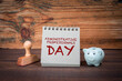 Administrative professionals day. Cardboard notepad on wooden texture table