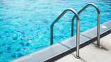Fototapeta  - Chrome handrails of the swimming pool. Hotel spa and resort accommodation. Ladder on the poolside. Relaxation in the summertime.