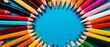 Brightly colored pencils arranged in a circle on a vibrant background, ideal for back to school promotions,