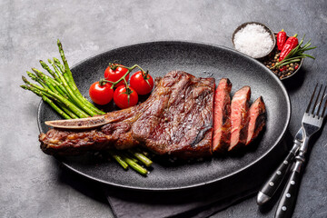 Wall Mural - Medium rare grilled Tomahawk beef steak with asparagus