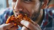 Handsome young man eating fried chicken, closeup shot, focus on the crispy texture, ideal for targeting young adults in ads