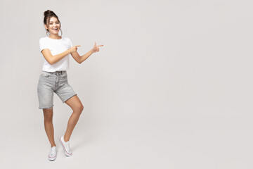 Wall Mural - Attractive young girl posing on a white background