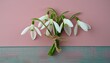 Delicate Blooms: Small Snowdrop Bouquet on Pink