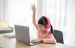 Portrait of Asian girl rise hand computer to learn online live lesson in elementary school. Student boy study in primary Children with gadgets at home. Education knowledge, technology internet network