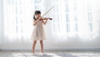 Portrait of young asian toddler little girl practice learning violin class room in white room at home or school isolated. Education, hobby leisure professional skill lifestyle concept