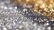 A blurry image of glittery silver and gold sparkles