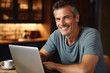 © Tetiana - Generated with AI picture of a handsome man working from home on a laptop