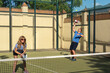 © Alejandro - Middle-Aged Man Performing High Padel Serve