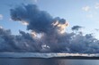Emerging heavy clouds above shoreline of bay near Razanac town, northern Dalmatia, Croatia, Adriatic. Sunlit by august evening sunshine. 